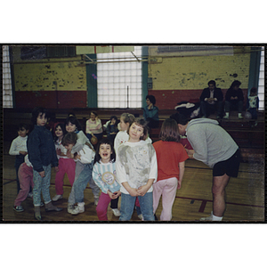 Two girls in a gymnasium pose for the camera