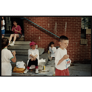 Children gather at the steps of a building during the Battle of Bunker Hill Road Race