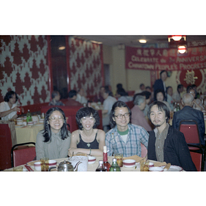 Two men and two women at a restaurant table during Chinese Progressive Association's Third Anniversary Celebration