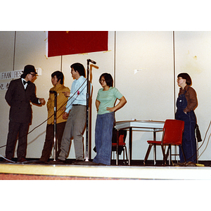 Performers in a theatrical sketch in the Josiah Quincy School auditorium about the normalization of U.S. and China relations