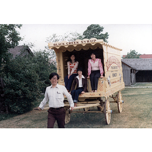 People posing with a Black Creek Syrup cart in Toronto