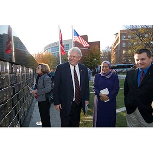 Neal Finnegan and a woman look at the Veterans Memorial at the dedication ceremony