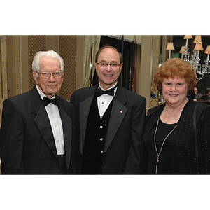 President Aoun, center, with two guests at the Huntington Society Dinner