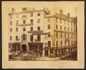 View of commercial buildings and street traffic, corner of Pearl Street and Milk Street