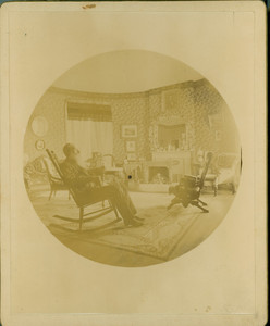 Richard H. Tucker III seated indoors, on a rocking chair, location unknown, undated