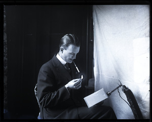 Donald W. Barnes, lighting a cigarette