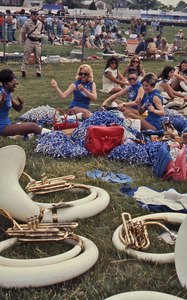 Young cheerleaders with instruments in foreground