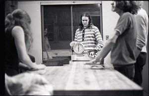 Julie Howard, Nick Carson, and Sammy Wolf (l. to r.) working in commune bakery