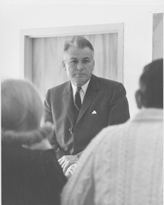 Bert T. Combs sitting in front of a group.