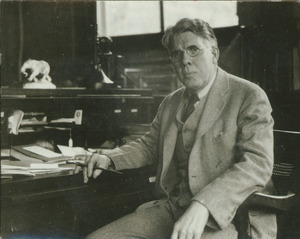 Clarence E. Gordon sitting indoors, at desk