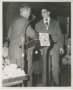 Bruce Barton shaking hands with graduate at Institute Day