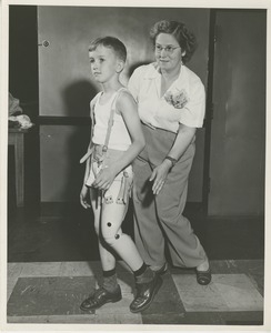 Boy walking during physical rehabilitation