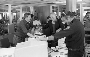 Mayor Kevin White, unidentified men and police officer smiling in Boston Police Dispatch Operations Center