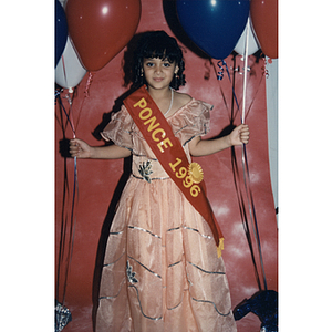 A young girl wears a Ponce 1996 sash during the Festival Puertorriqueño