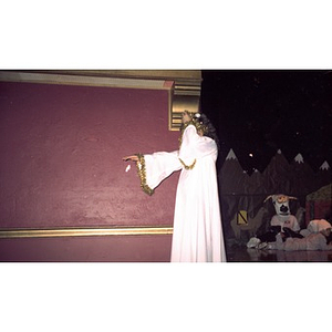 Girl dressed as an angel walks on the stage during a Christmas pageant performance on Three Kings Day.