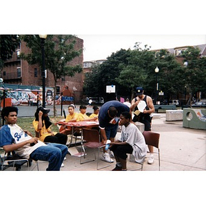 Youth staffing a table for an event that was held outside in the playground.