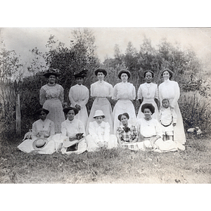 Group photograph, women in white and a lone child