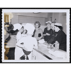 Members of the Tom Pappas Chefs' Club speak with a group of unidentified adults