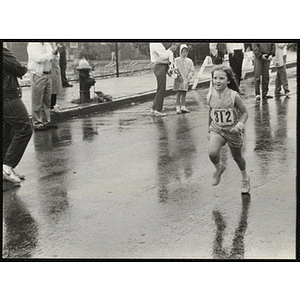 A girl runs in the Battle of Bunker Hill Road Race