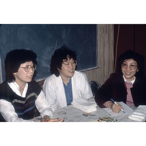 Women talking in front of a chalkboard