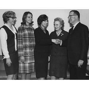 Dr. Asa S. Knowles, President of Northeastern University, is welcomed to the Tufts University campus in Medford by student leaders of the Boston-Bouvé College of Physical Education and Physical Therapy