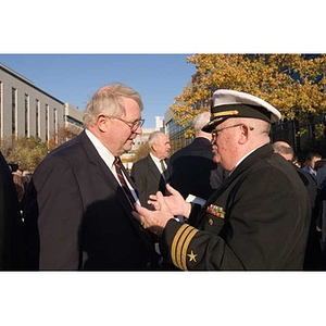 Neal Finnegan converses with another man at the Veterans Memorial dedication