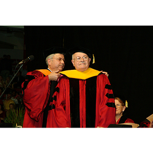 George Kostas being hooded during the commencement ceremonies