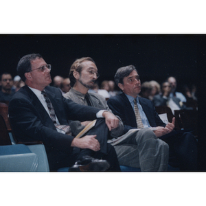 Comptroller Kneeland, Professor Robinson, and President Freeland sit in the audience at a General University Meeting