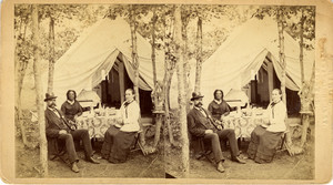 Stereograph of three people seated at a garden table, in front of a tent, ca. 1878