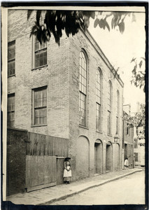 Exterior view of the African Meeting House with a woman standing on the sidewalk, Boston, Mass., ca. 1885
