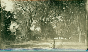Two girls hand-in-hand facing camera on Main Street, near the Sheldon House, Deerfield, Massachuetts, undated