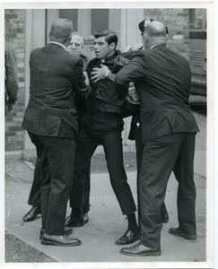 Fr. Nicholas Riddle being forced from St. John's Cathedral after he attempted to read a statement against the war in Vietnam at the church. He and 7 others were arrested and charged with disorderly conduct, posting bail of $250 each
