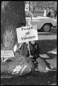 Young African American antiwar protester holding a sign reading 'Peace in Vietnam': Washington Vietnam March for Peace