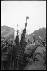 Anti-Vietnam War protesters hold up a burning clutch of miniature American flags distributed by the Boy Scouts during the Counter-inaugural demonstrations, 1969