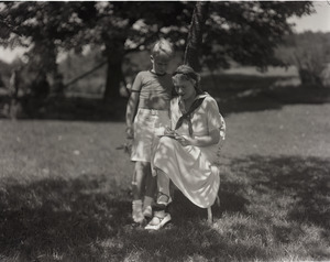 Dorothy Thompson seated on the lawn with son Michael Lewis