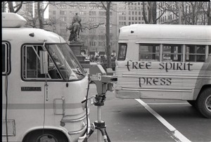Free Spirit Press bus and Channel 5 news van parked, camera nearby, during interview by Channel 5 news