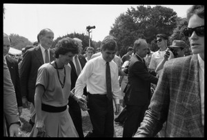 Kitty and Mike Dukakis (hand over face) walking hand-in-hand at the 25th Anniversary of the March on Washington