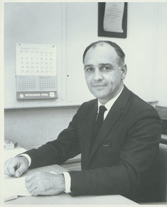 William F. Field at a desk