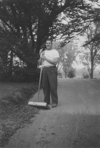 Edmund F. Freitas with push broom