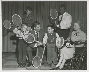 People with disabilities hold tennis equipment