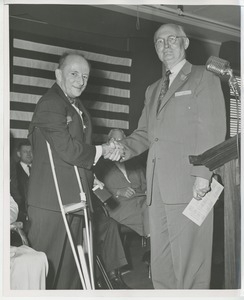 Unidentified men shaking hands at Institute Day