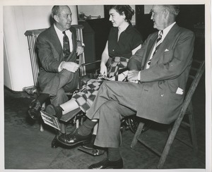 Woman in wheelchair talking with two men