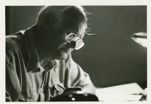 Professor John Cox writing in his office