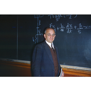 Joseph Spear in front of a chalkboard