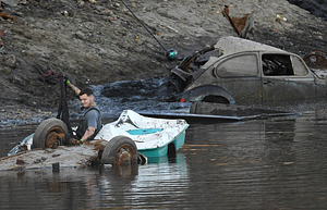 A workman preparing a vehicle to be removed from Lake Massasoit (2020)
