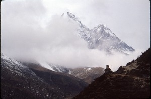 Chorten (sacred shrine) in foreground as mists enshroud Ama Dablam