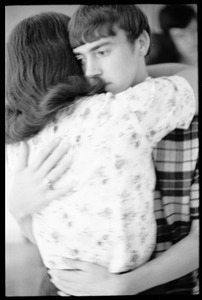 Teenage long hair: teenaged girl and long-haired boy embrace