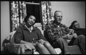 Mildred and Richard Loving seated on a couch with Richard's father (from left)