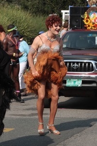 Parade marcher in dress with a furry hem : Provincetown Carnival parade