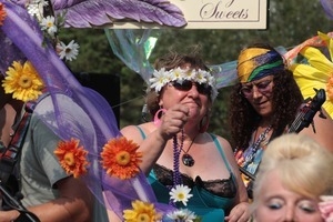 Purple Feather chocolate shop float in the parade, throwing beads to the crowd : Provincetown Carnival parade